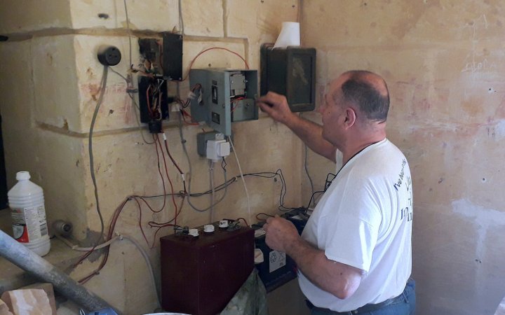 Carmel Bigeni doing maintenance work on the Basilica’s clock